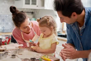 Parents and a child making cookies.