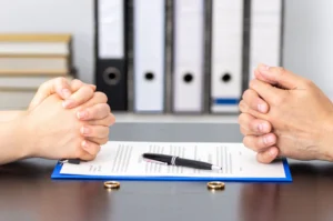 Two people signing divorce papers.