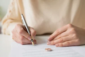 Woman filling divorce paperwork.